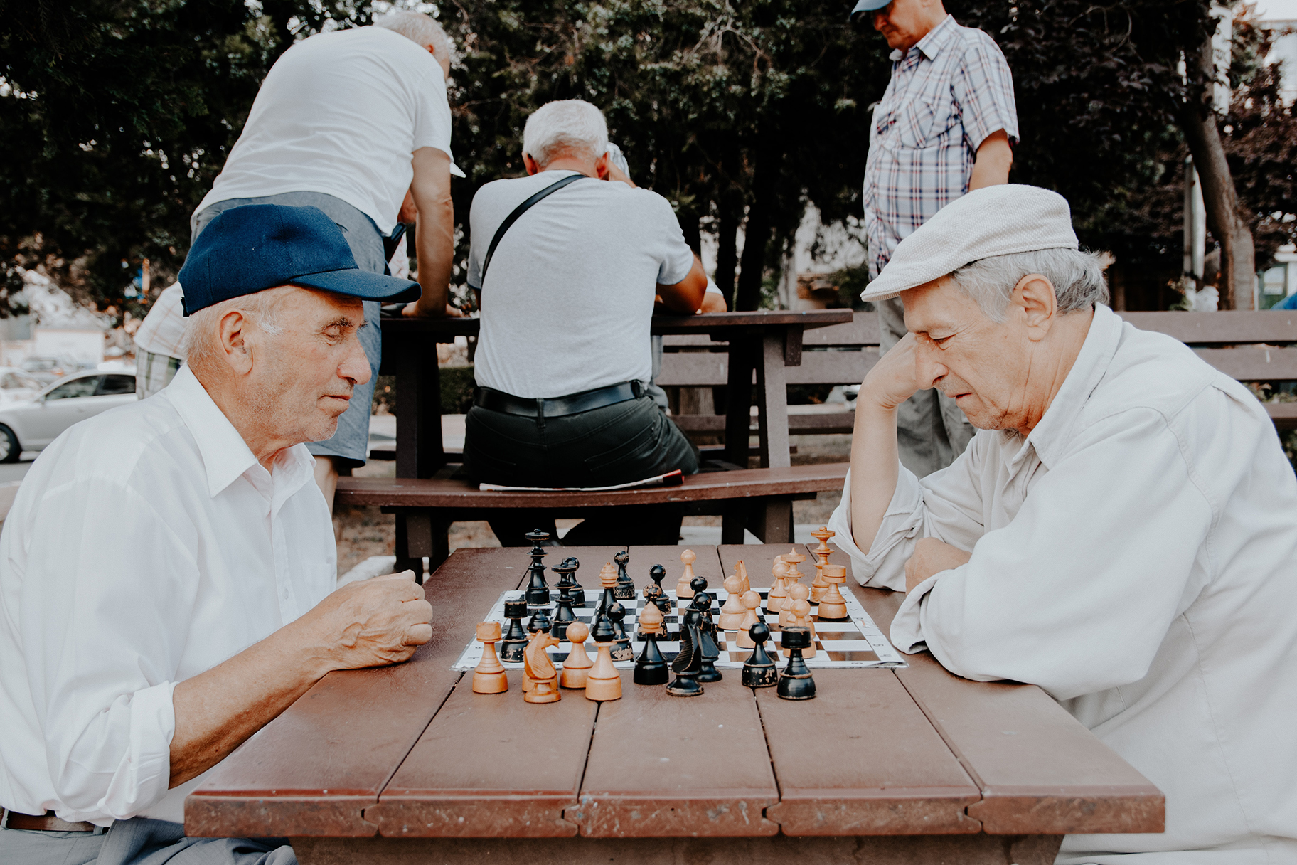 Veterans playing chess in a park